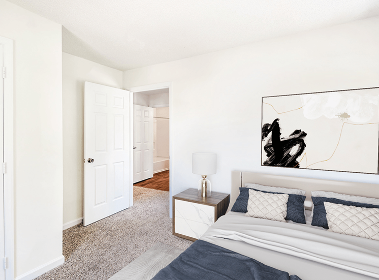 Virtually staged; Carpeted Bedroom with Closet adn Open Doorway Showing Hallway to Bathroom with bed and night stand and grey/blue accent colors